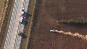 Car chase in a field